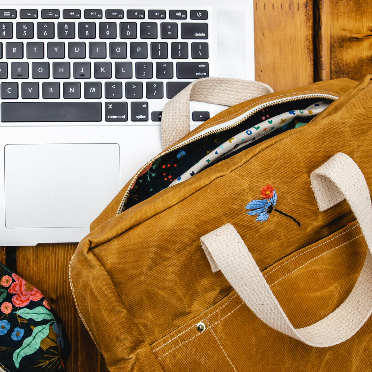 Waxed canvas backpack with embroidered details and Rifle Paper Co fabr ...